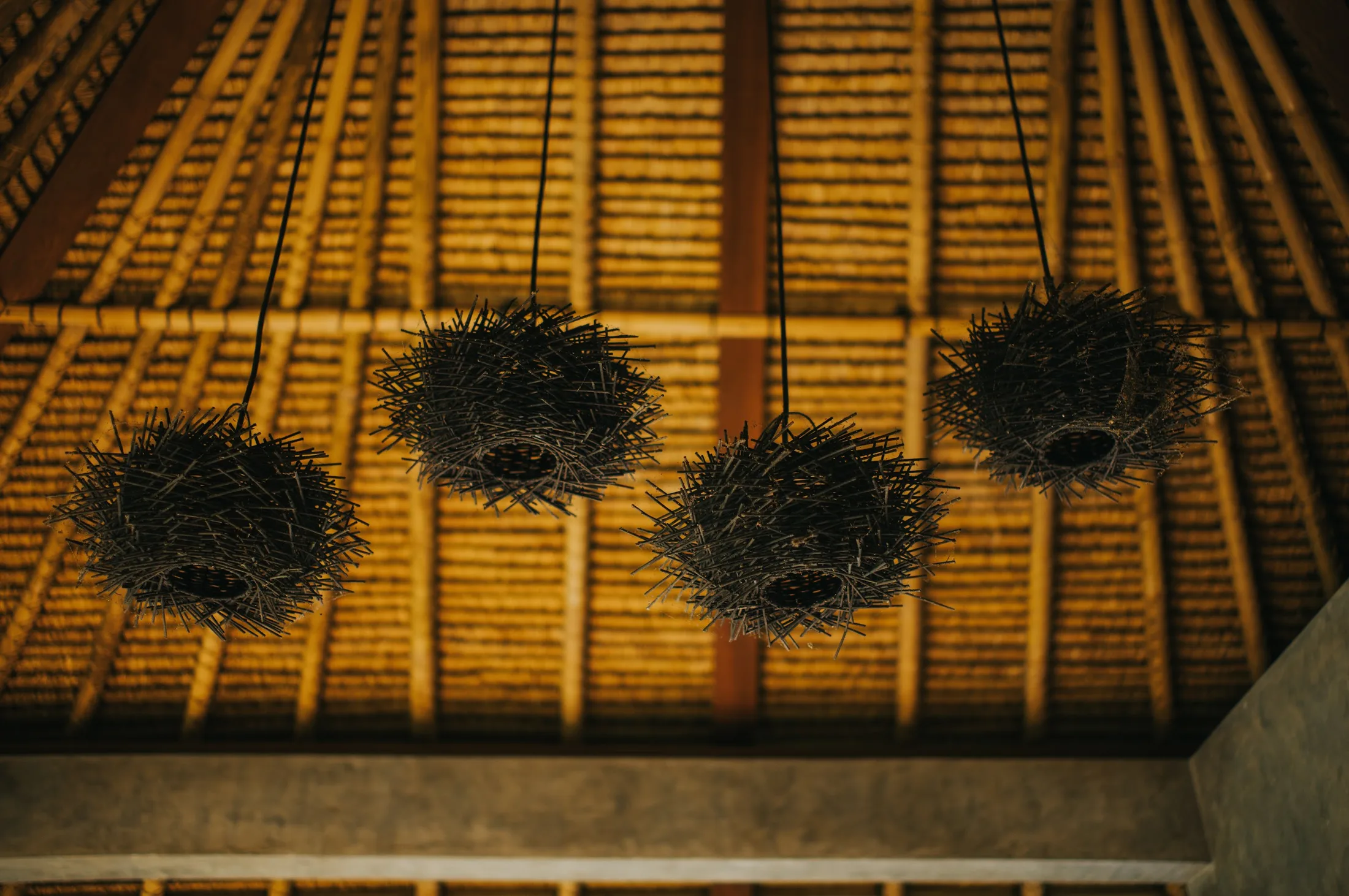 Handmade pendant lights beneath a timber ceiling